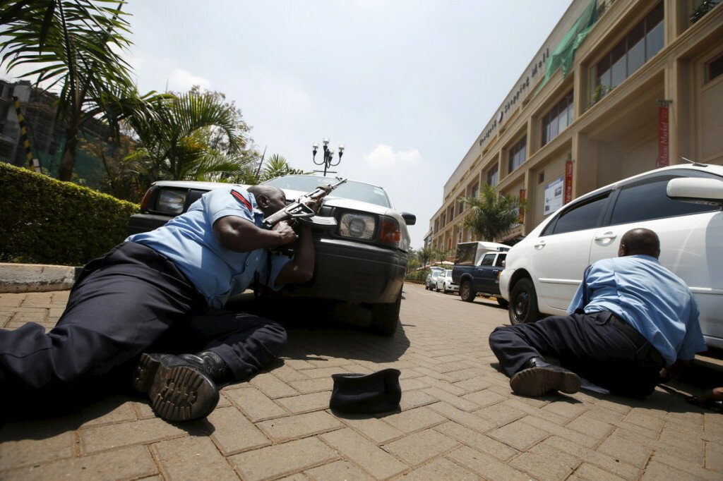 File photo of policemen taking cover near the main entrance of Westgate shopping mall during an attack by gunmen in Nairobi