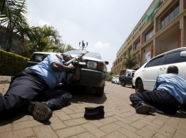 File photo of policemen taking cover near the main entrance of Westgate shopping mall during an attack by gunmen in Nairobi